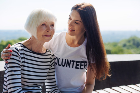 Admirable genuine woman keeping a company for senior ladyの写真素材