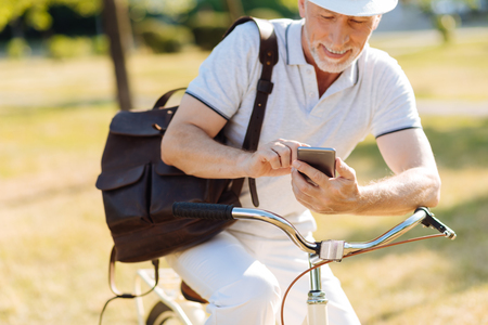 Delighted bearded man using his telephoneの写真素材