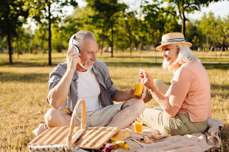 Positive elderly couple having picnicの写真素材