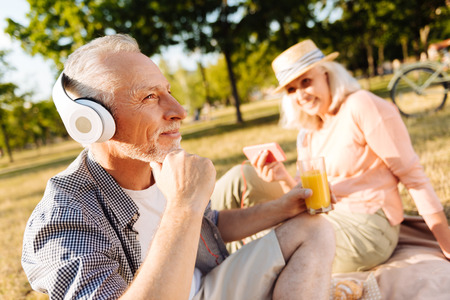 Thoughtful bearded male person enjoying picnic on natureの写真素材