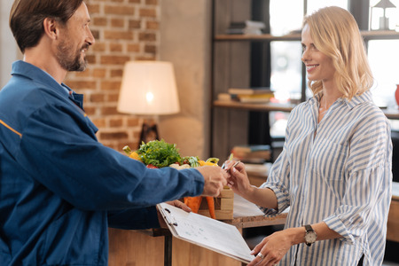 Neat attentive man asking for signatureの写真素材