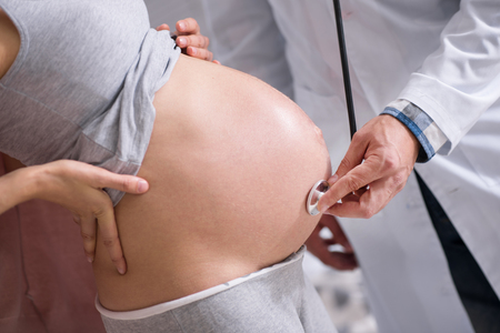 Pregnant woman standing in semi positionの写真素材