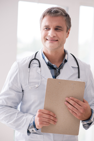 Professional medical worker holding folder with documentsの写真素材