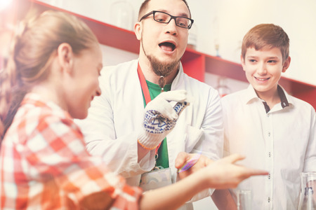 Handsome boy standing behind instructorの写真素材