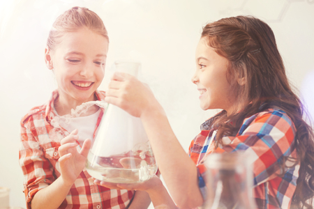 Pretty girls expressing positivity while looking at their bottleの写真素材