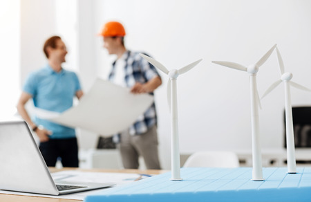 Engineer discussing a power station blueprint with a builderの写真素材