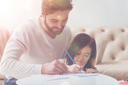 Adorable nice family drawing togetherの写真素材