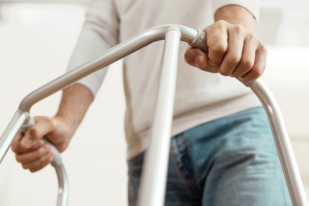 Nice elderly man holding a walking frameの写真素材