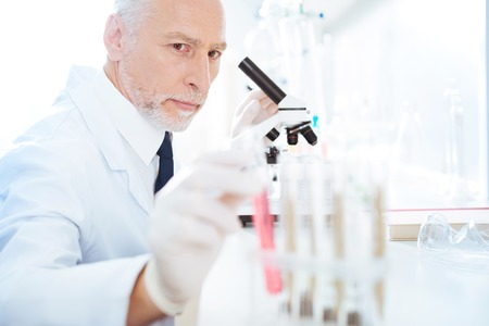 Handsome medical worker sitting in laboratoryの写真素材