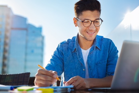Friendly looking freelancer working outdoorsの写真素材
