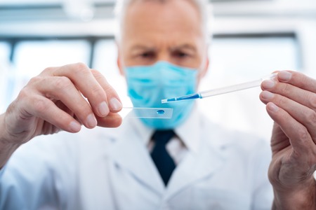 Attentive medical worker examining dropsの写真素材