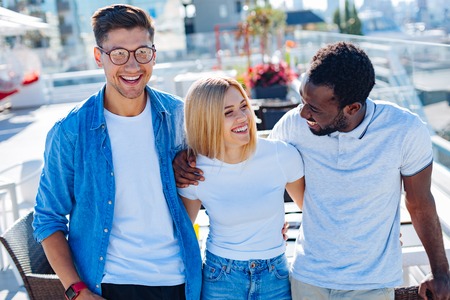 Childhood friends joking and smiling togetherの写真素材