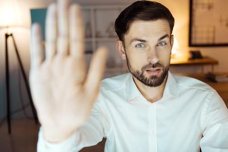 Handsome male person showing his handの写真素材
