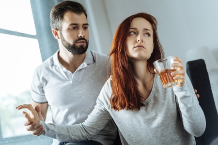 Unhappy sad woman being alcohol addictedの写真素材