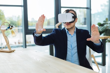 Smart handsome businessman being in 3d realityの写真素材