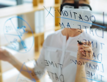 Positive nice woman writing on the glass screenの写真素材