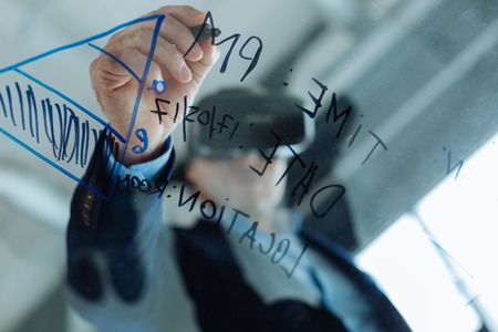 Nice handsome man writing on the glassの写真素材