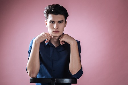 Confident brunette touching his shirtの写真素材