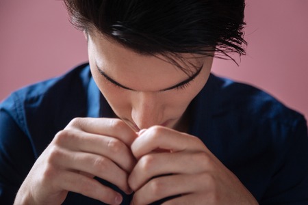 Portrait of serious man that bowing headの写真素材