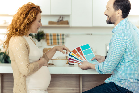 Amused family holding papers with colorsの写真素材