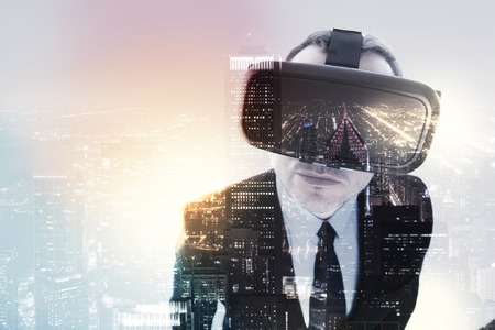 Businessman in VR headset looking at camera