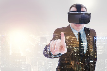 Young businessman in VR headset pointing with finger