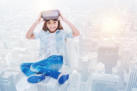 Little girl removing VR headset and smiling