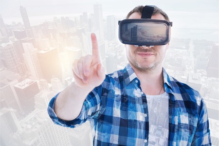 Smiling man in VR headset raising his index fingerの写真素材