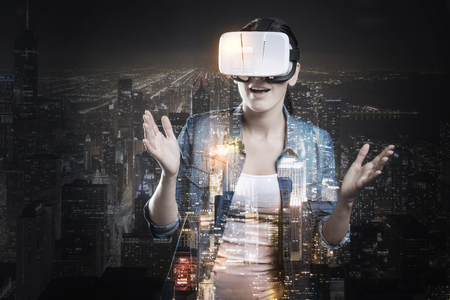 Pleasant woman playing VR game and being scaredの写真素材