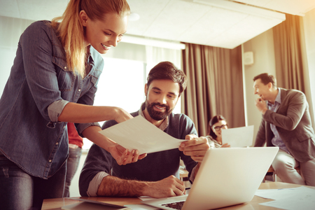 Positive attractive woman talking to her colleagueの写真素材