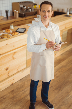 Happy cheerful man being at workの写真素材