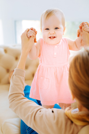 Amazing smiling child spending time with a loving motherの写真素材
