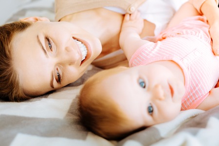 Loving mother looking softly at her pretty baby