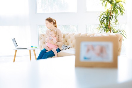 Concentrated woman sitting with a little daughter