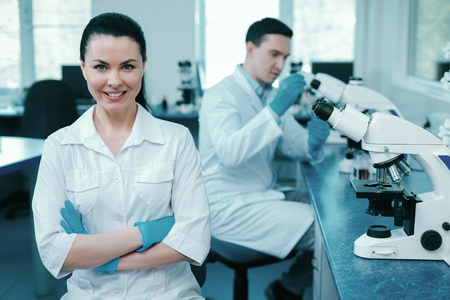 Confident scientist crossing arms on chestの写真素材