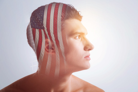 Independence Day. Focused liberal inspired guy thinking about the fate of his country examining the distance while his head is in profileの写真素材