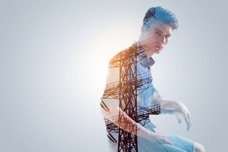 Shocking idea.  Sweet positive confident guy reaching the perfection sitting sideways with his hand resting on  the handleの写真素材