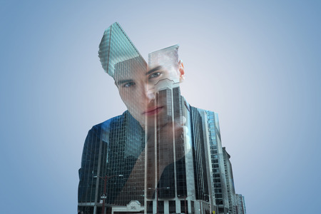 Handsome dreamy gentleman looking into the camera confidently while resting his chin on his hand and thinking about something.の写真素材