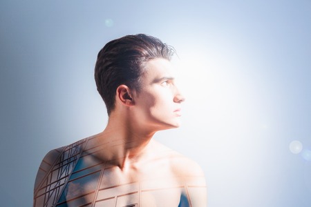 Modern architecture. Nice pleasant creative man turning his head and imagining a building while thinking about modern architectureの写真素材