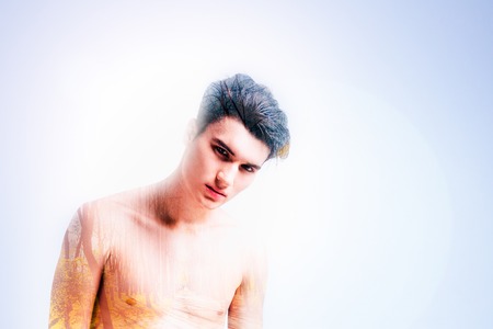 Beautiful season, Serious handsome pensive man standing and imagining an autumn forest while enjoying this seasonの写真素材