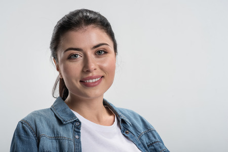 Good news. Portrait of good looking tender positive woman  getting experience while participating  and wearing jeans shirtの写真素材
