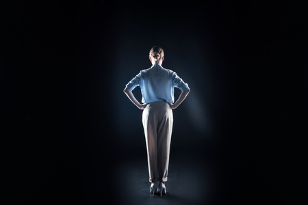 Modern world. Positive nice attractive woman standing and looking in front of her while being in virtual realityの写真素材