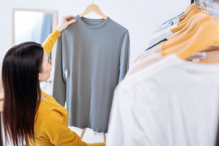 Beautiful color. Fashionable young skilled worker of a professional atelier evaluating a new...
