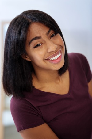 Beautiful portrait. Cheerful enthusiastic young specialist looking happy while being at work in a fashionable atelierの写真素材
