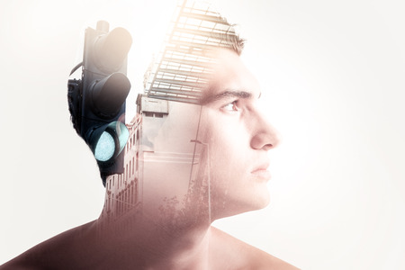 Pretty positive young guy posing in profile while looking up and promoting new ways of thinking