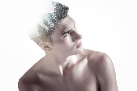 Pensive reflective appealing guy turning away from camera while gazing up and looking for inspirationの写真素材