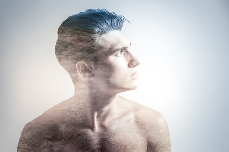 Nature inspires. Reflective nice good looking guy posing in profile while looking up and dreamingの写真素材