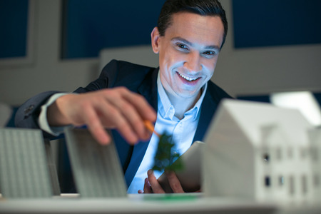 engineer holding tablet while smiling and staring at the cameraの写真素材