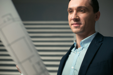 architect trying to concentrate while looking at blueprintの写真素材