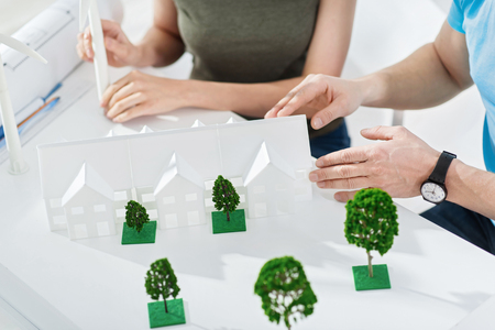 Happy landscapers. Successful professional determined landscape designers working together on the project and making a miniature and discussing workの写真素材
